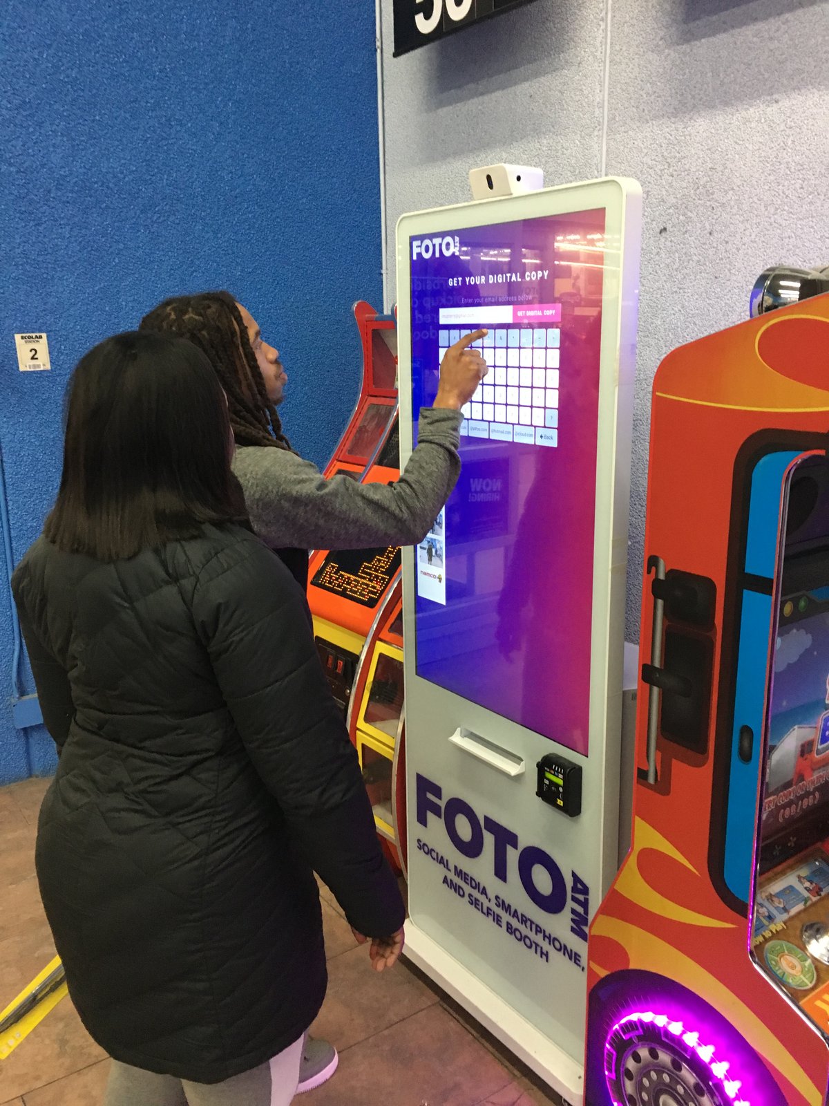Customer using FotoATM kiosk at Walmart